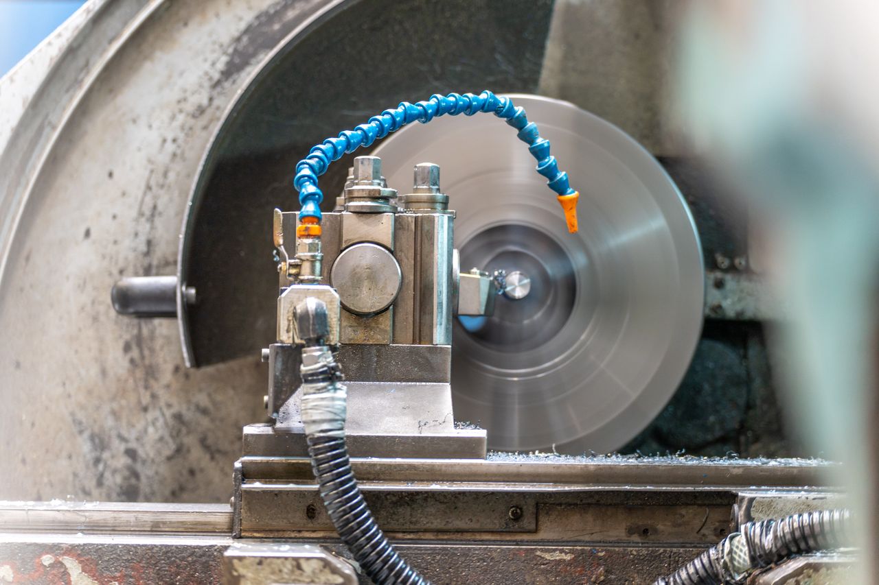 Close-up of a spinning lathe machine in an industrial workshop setting.